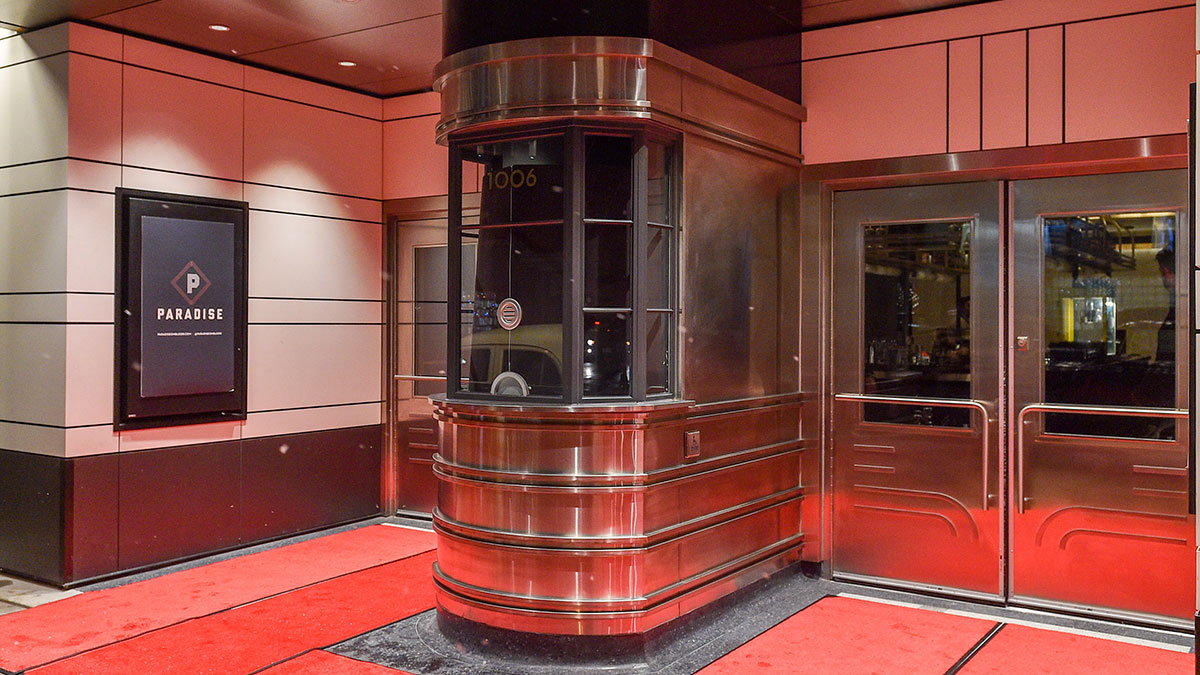 Restored stainless steel ticket booth at the entrance of Paradise Theatre.